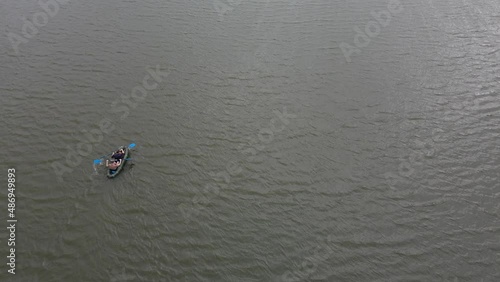 Russia, Volga, 07.08.2021. People in a boat float on the river in sunny weather, aerial video. Water recreation concept. editorial use only.