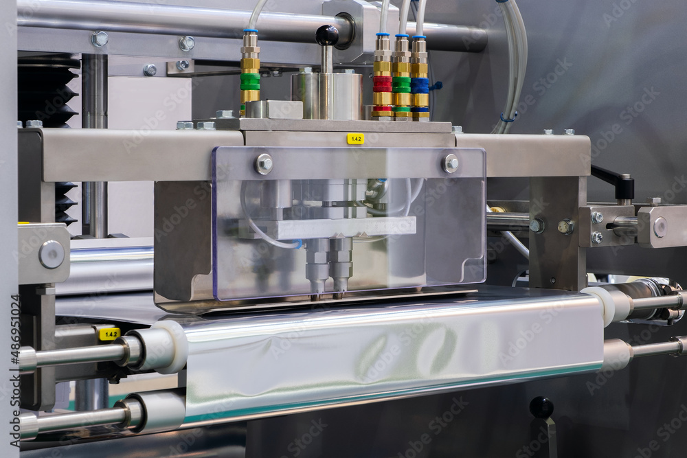 Conveyor Belt Food.Factory for the production of food. Production line with packaging. Food products in plastic packaging on the conveyor. food production concept Conveyor Belt Food.Factory for the production of food. Production line with packaging. Food products in plastic packaging on the conveyor. food production concept