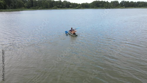 Russia, Volga, 07.08.2021. People in a boat float on the river in sunny weather, aerial video. Water recreation concept. editorial use only.