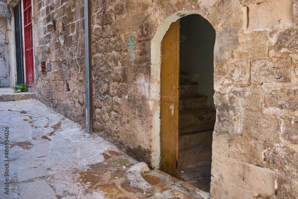 Doors of middle-eastern town. Narrow paved street of Mardin, Turkey