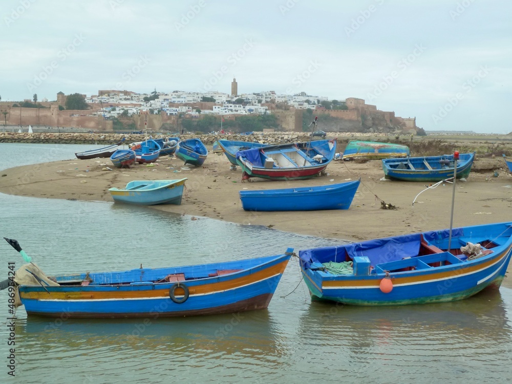Colorful fishing boats on Bou Regreg river, charming Sale, neighboring city to Rabat, in the background. Morocco.