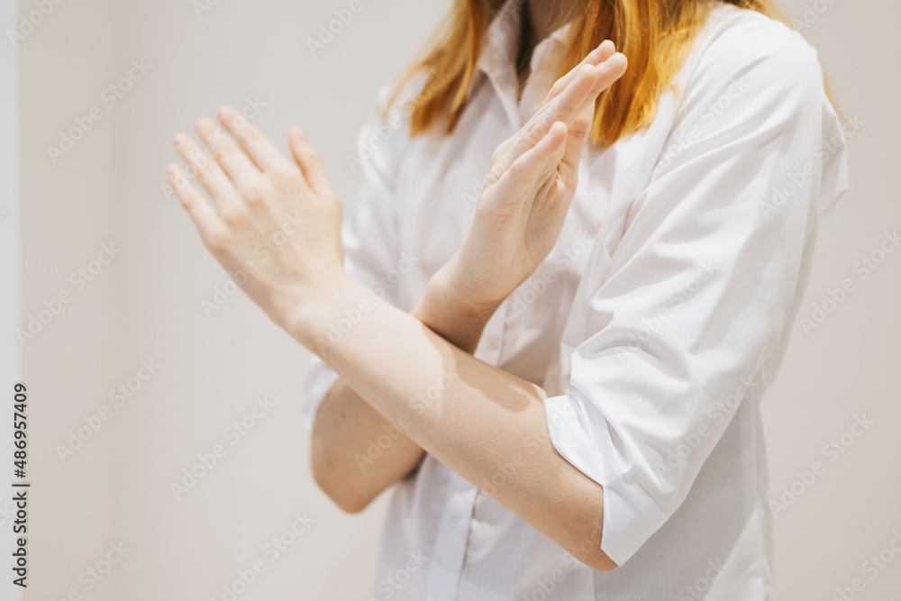 teenage girl generation Z with her arms crossed at her chest demonstrates Break The Bias symbol of international women's day principles of feminism, gender equality and support