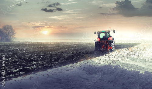 Tractor plowing a field in winter © Dusan Kostic