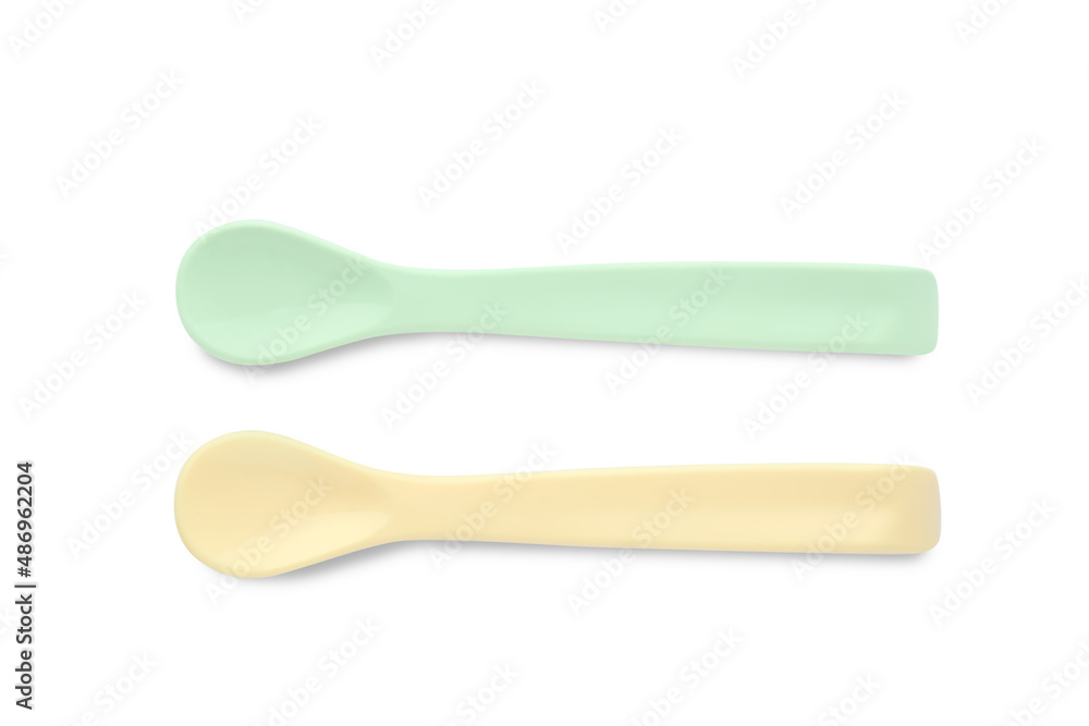 Plastic spoons isolated on white, top view. Serving baby food