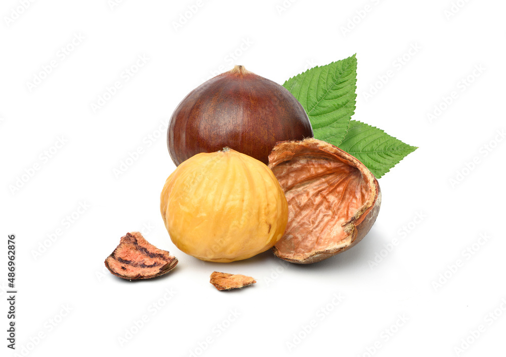 Close-up Chestnuts with peeled with green leaves isolated on white background. Close-up Chestnuts with peeled with green leaves isolated on white background.
