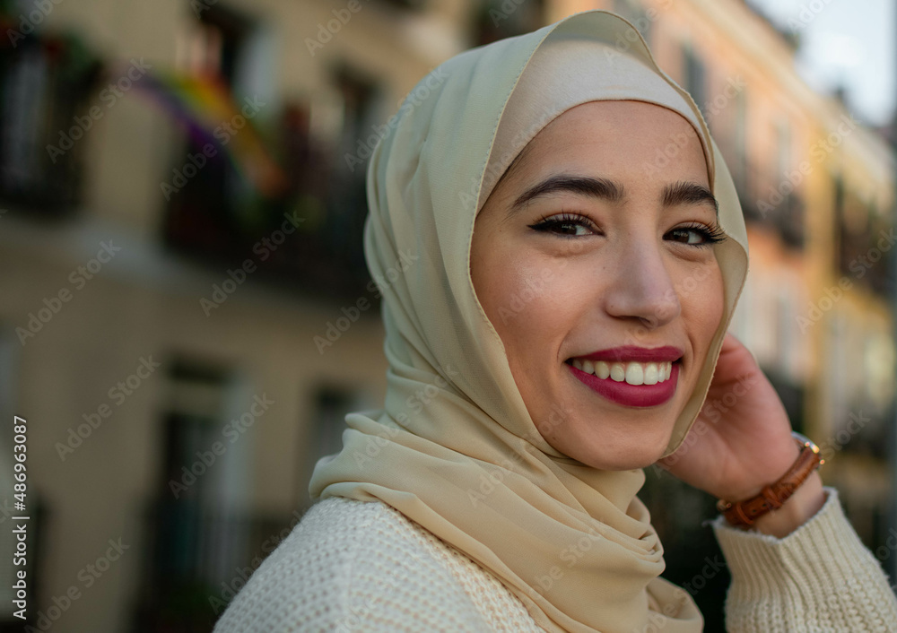 Pretty young muslim woman in hijab scrolling outdoors Pretty young muslim woman in hijab scrolling outdoors