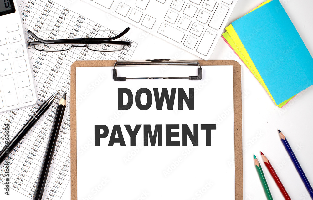 Clipboard with text DOWN PAYMENT and keyboard and chart on white background. Clipboard with text DOWN PAYMENT and keyboard and chart on white background.