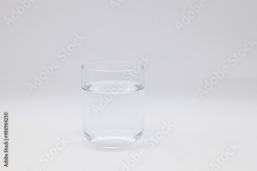 Transparent glass of pure water on a white background