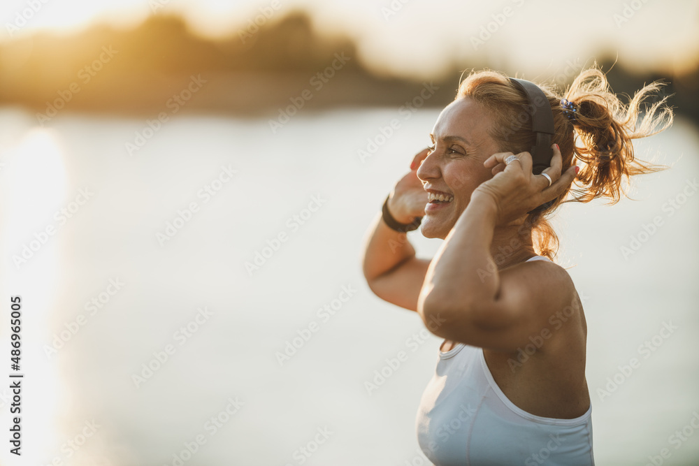Woman Listening Music And Preparing To Training Near The River