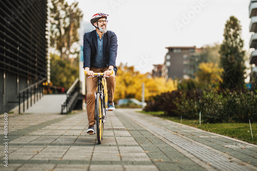 A Businessman Traveling To Work With A Bike photo