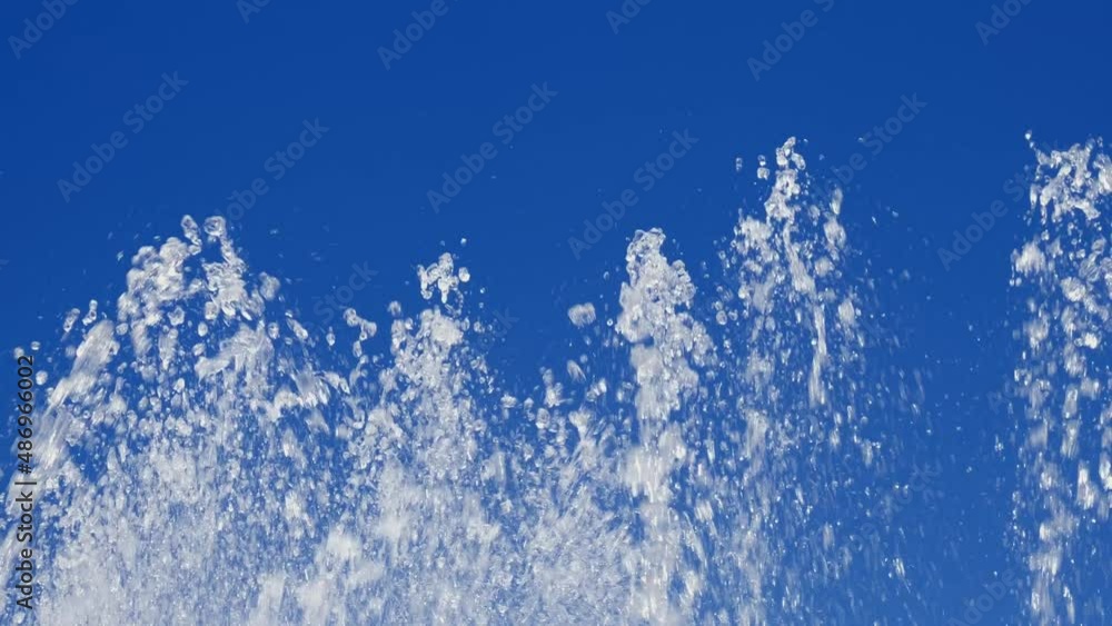 A large beautiful fountain against the blue sky. Water and waves. Natural texture. Slow motion fountain A large beautiful fountain against the blue sky. Water and waves. Natural texture. Slow motion fountain