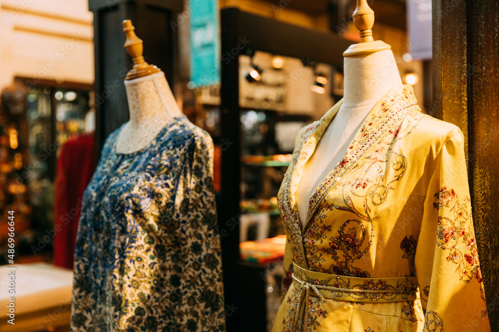 Mannequins dressed in beautiful female woman traditional oriental clothes In store of shopping center. Oriental dress in shop.Popular souvenirs from Dubay UAE United Arab Emirates. Shopping in Dubai S...