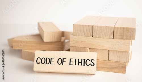 The Code of Ethics text is written on one of the many scattered wooden blocks