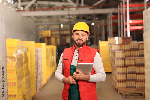 Man with tablet working at warehouse. Logistics center