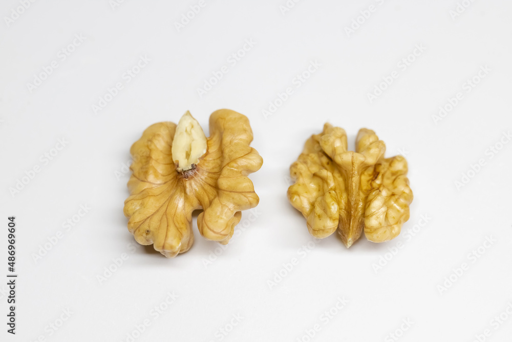 Walnut standing on a white background. The focus is on walnuts. Walnut, which is a healthy food source.