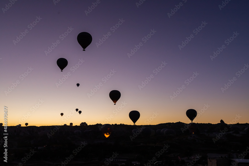 Balloons taking off at sunrise in Cappadocia Balloons taking off at sunrise in Cappadocia