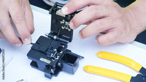  Wire connection with Fiber Optic Fusion Splicing machine,fiber optic cable splice machine in workTechnician Fiberoptic Fusion Splicing. Worker connecting for Cable Internet signal  photo