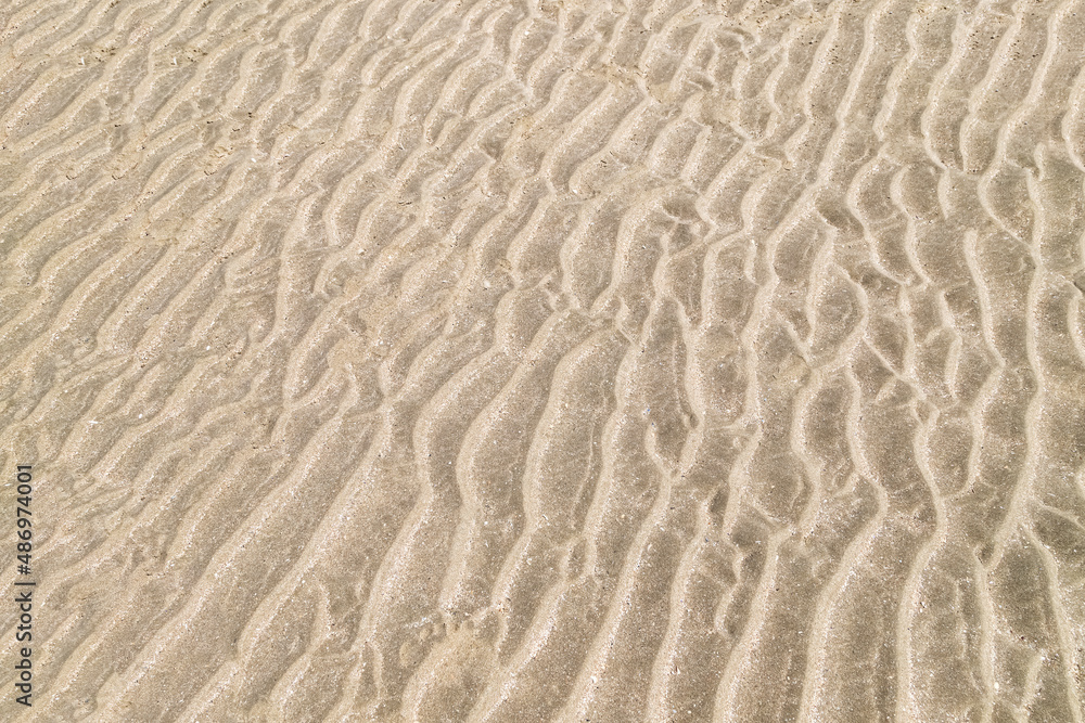 Sand on the beach in Trouville, France. Texture, close up. Sand on the beach in Trouville, France. Texture, close up.