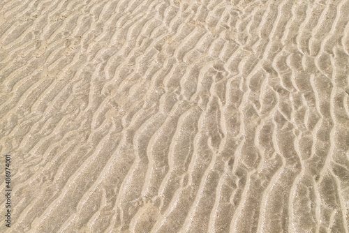 Sand on the beach in Trouville, France. Texture, close up.