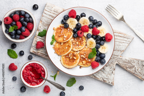 Keto diet pancakes made or almond flour, served with berries.