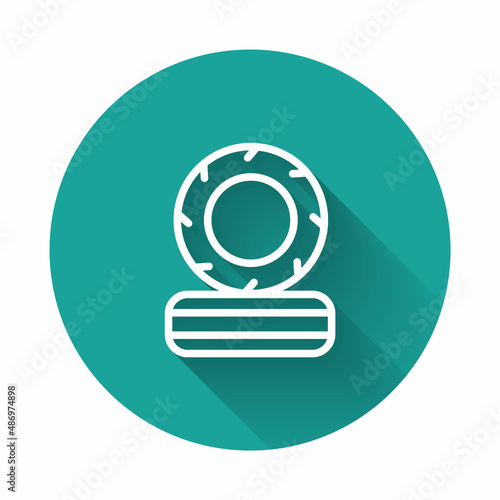 White line Lying burning tires icon isolated with long shadow. Green circle button. Vector