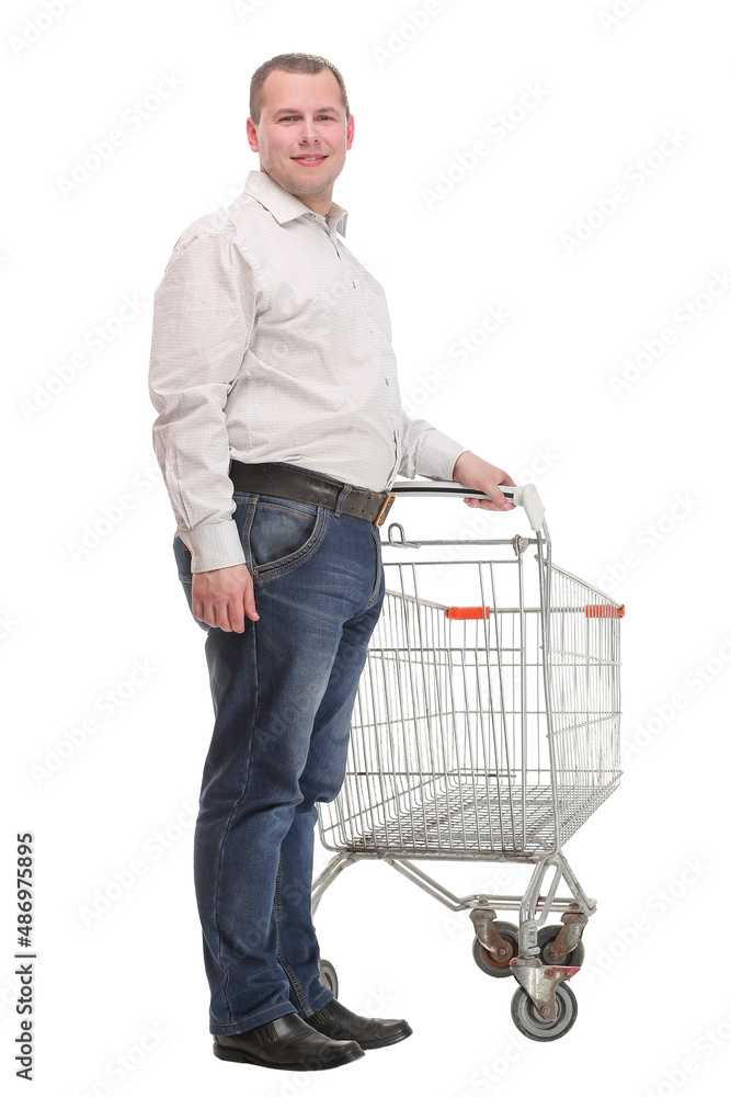 Happy young man with empty shopping cart isolated on white background Happy young man with empty shopping cart isolated on white background