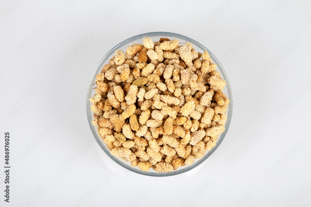 Dried mulberry in glass bowl on white background Dried mulberry in glass bowl on white background