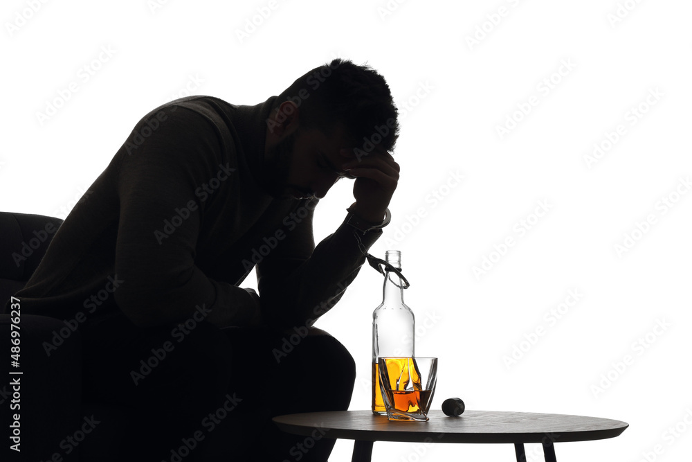 Silhouette of addicted man in handcuffs with alcohol bottle on white background Silhouette of addicted man in handcuffs with alcohol bottle on white background