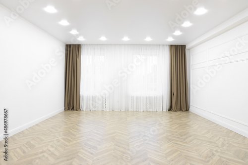 Empty room with white walls  large window and wooden floor