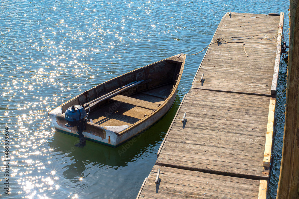row boat sitting idle on calm seas row boat sitting idle on calm seas