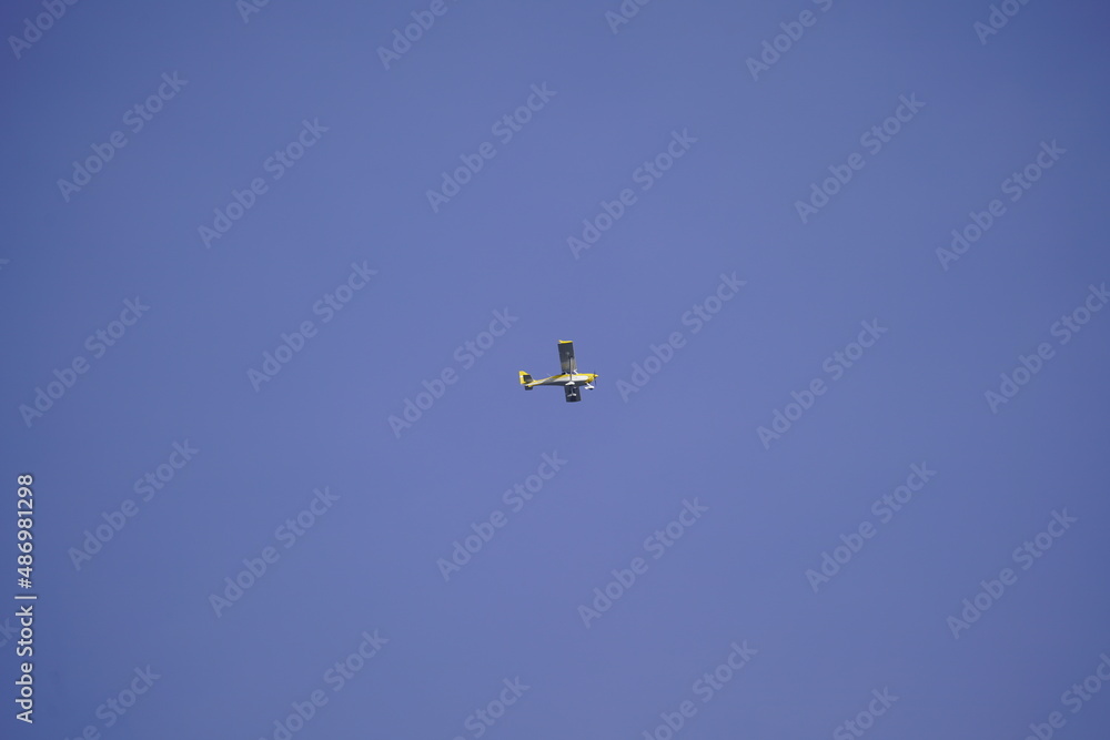 A small motor plane in sky