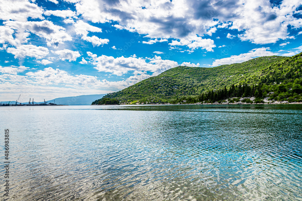 bay in Ploce in Croatia, summer day in a holiday resort in Croatia, clear water, boats in ploce harbor, green hills in the mediterranean part of Croatia, Dalmatia