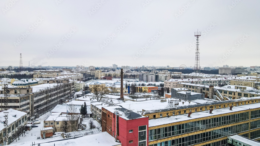 Beautiful top view of cityscape with tv tower, ferris wheels, factory and buildings in winter. Beautiful top view of cityscape with tv tower, ferris wheels, factory and buildings in winter.