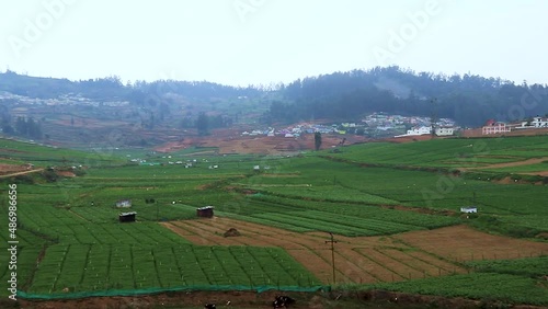 countryside rural farming field with mountain and flat sky background video taken at ooty tamilnadu india. photo