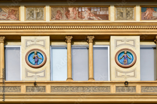 Fotografie Detail of the façade of an ancient palace with bas-relief decorations and fresco