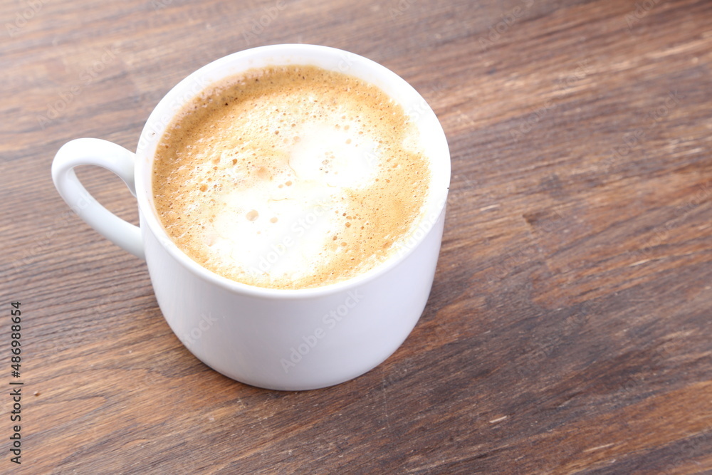 Coffee with milk cup with biscuit on white wood background. Coffee with milk cup with biscuit on white wood background.