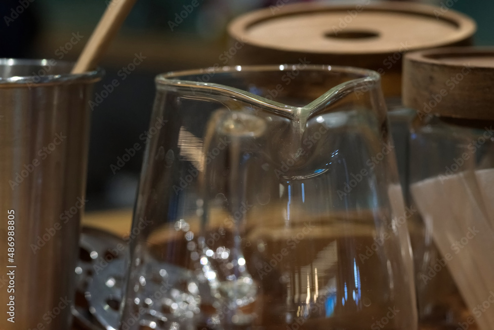 A transparent glass cup on a wooden table with blur background A transparent glass cup on a wooden table with blur background