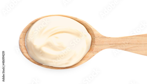 Wooden spoon with tasty mayonnaise isolated on white, top view