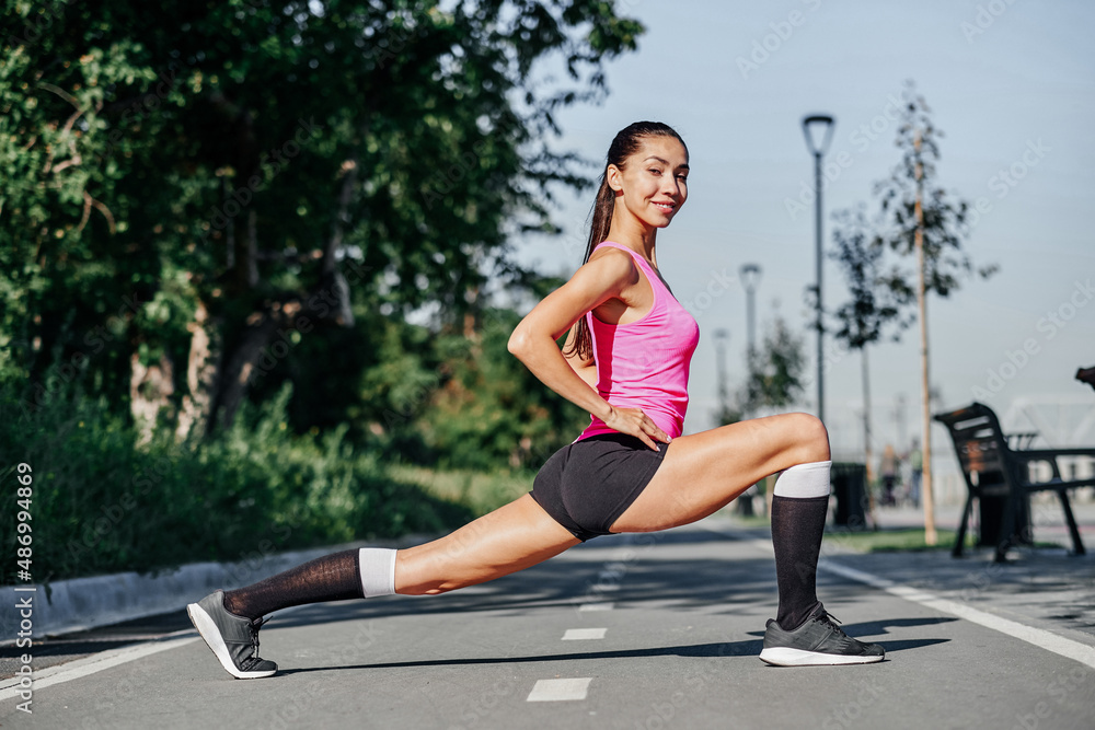 Fitness young woman stretching legs after run. outdoors sport portrait Fitness young woman stretching legs after run. outdoors sport portrait