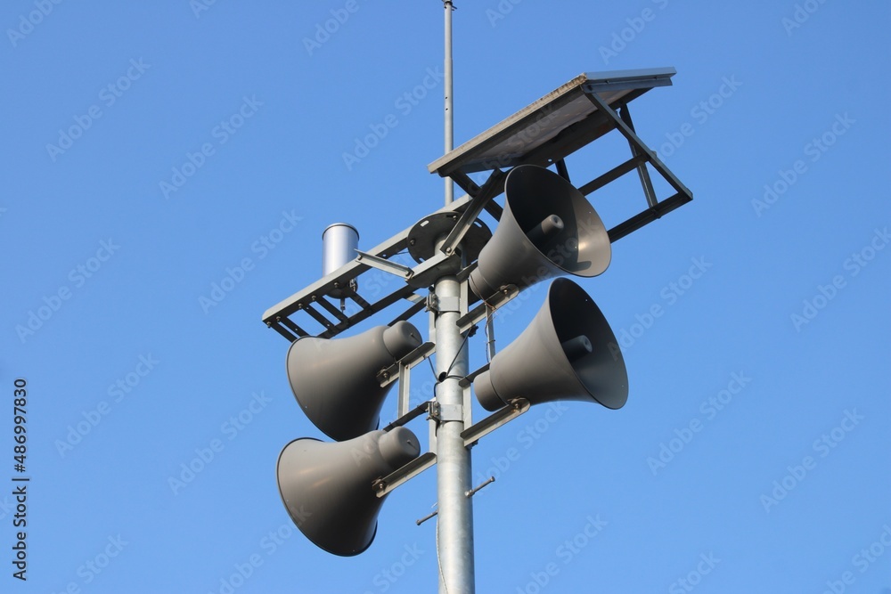 Outdoor loudspeaker system, against clear blue sky Outdoor loudspeaker system, against clear blue sky