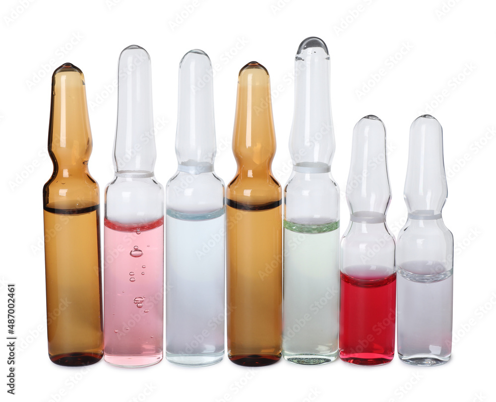 Glass ampoules with pharmaceutical products on white background Glass ampoules with pharmaceutical products on white background