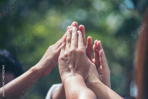 Diversity multiethnic high five group of business people success team hands together. Collaborate Volunteer friendship hands raise up mission Business partner. Group of teamwork high five together