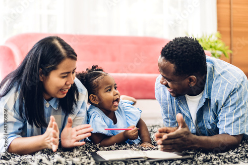 Portrait of enjoy happy love black family african american father and mother with little african girl child smiling and play having fun moments good time in room at home