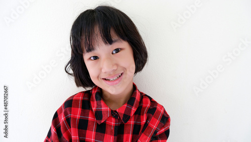 Obraz na plátně A picture of a half-bred girl wearing a red shirt smiling face against the backd