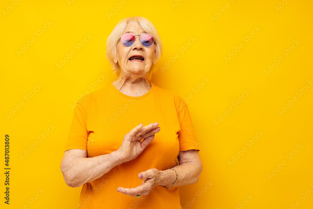 Photo of retired old lady happy lifestyle in yellow t-shirts cropped view Photo of retired old lady happy lifestyle in yellow t-shirts cropped view