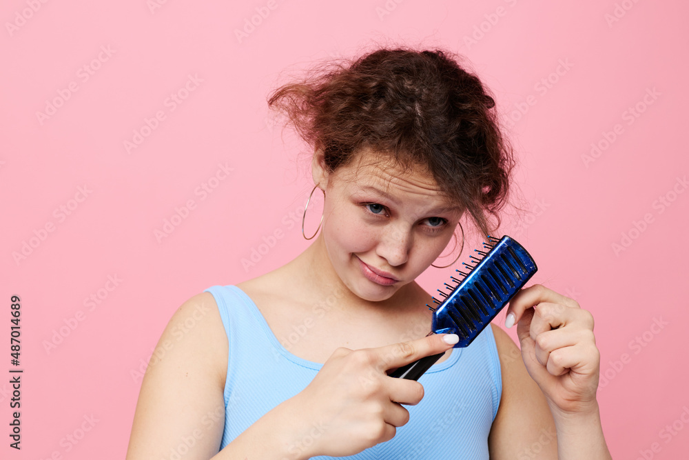 teenager girl removes hair on a comb dissatisfaction close-up unaltered teenager girl removes hair on a comb dissatisfaction close-up unaltered
