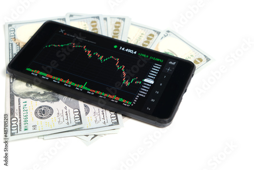 Stock exchange chart on smartphone screen and hundred dollar bills on white background.Concept,shares, business and finance.