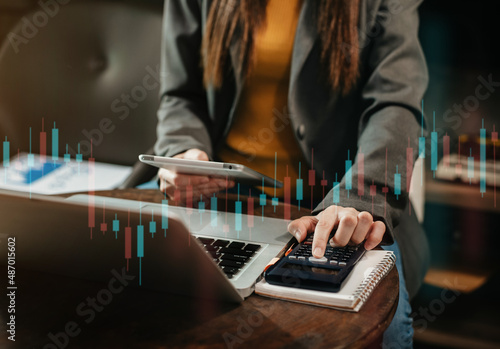 Businessmen trading stocks online. Stock brokers looking at graphs, indexes and numbers on tablet.