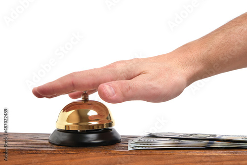 Pressing your hand bell hotel service and dollars table.Concept hotel, travel and paid holidays.