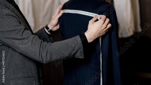 Tailor measuring business man